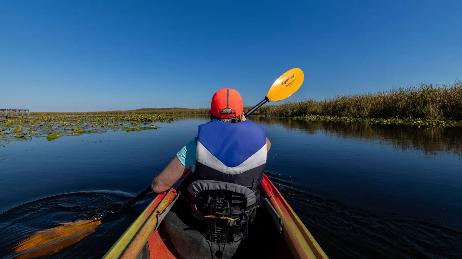 Kayaker exploring a Lowcountry salt marsh on a bright day